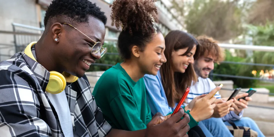 People smiling on their mobile phones