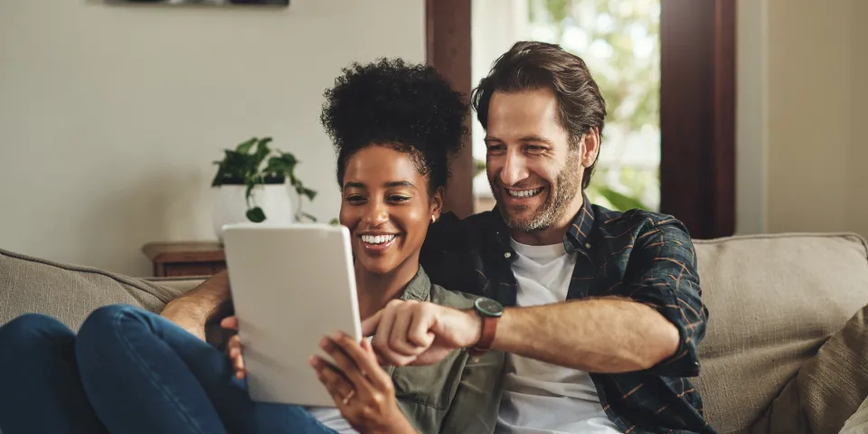 couple looking at a document and smiling