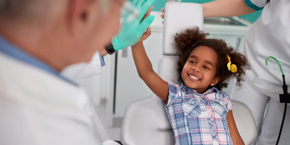 child getting teeth examined by dentist