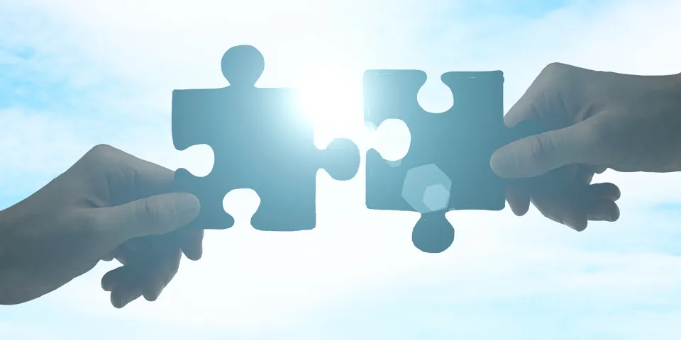 puzzle pieces with sunshine in the background